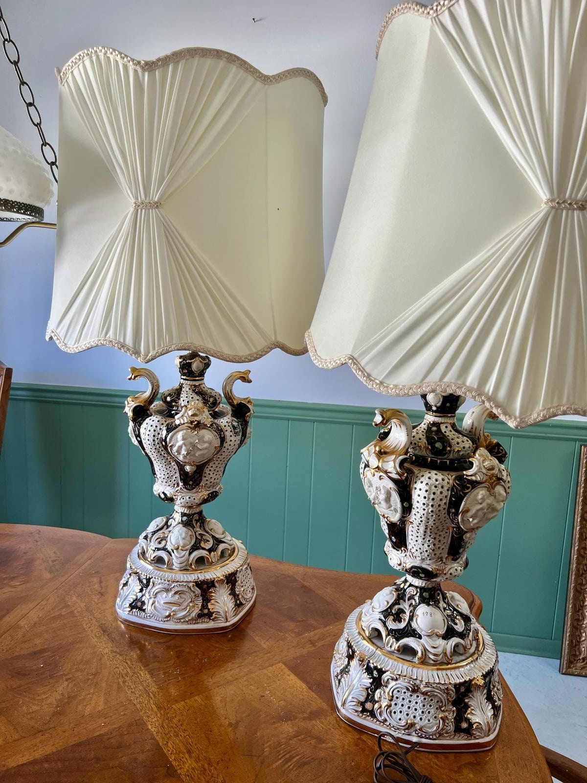 Baroque Porcelain Table Lamps Pair Ornate Cherub Motif Black White Gold Embellished Romantic Rococo Style Sculptural Lighting Decoration