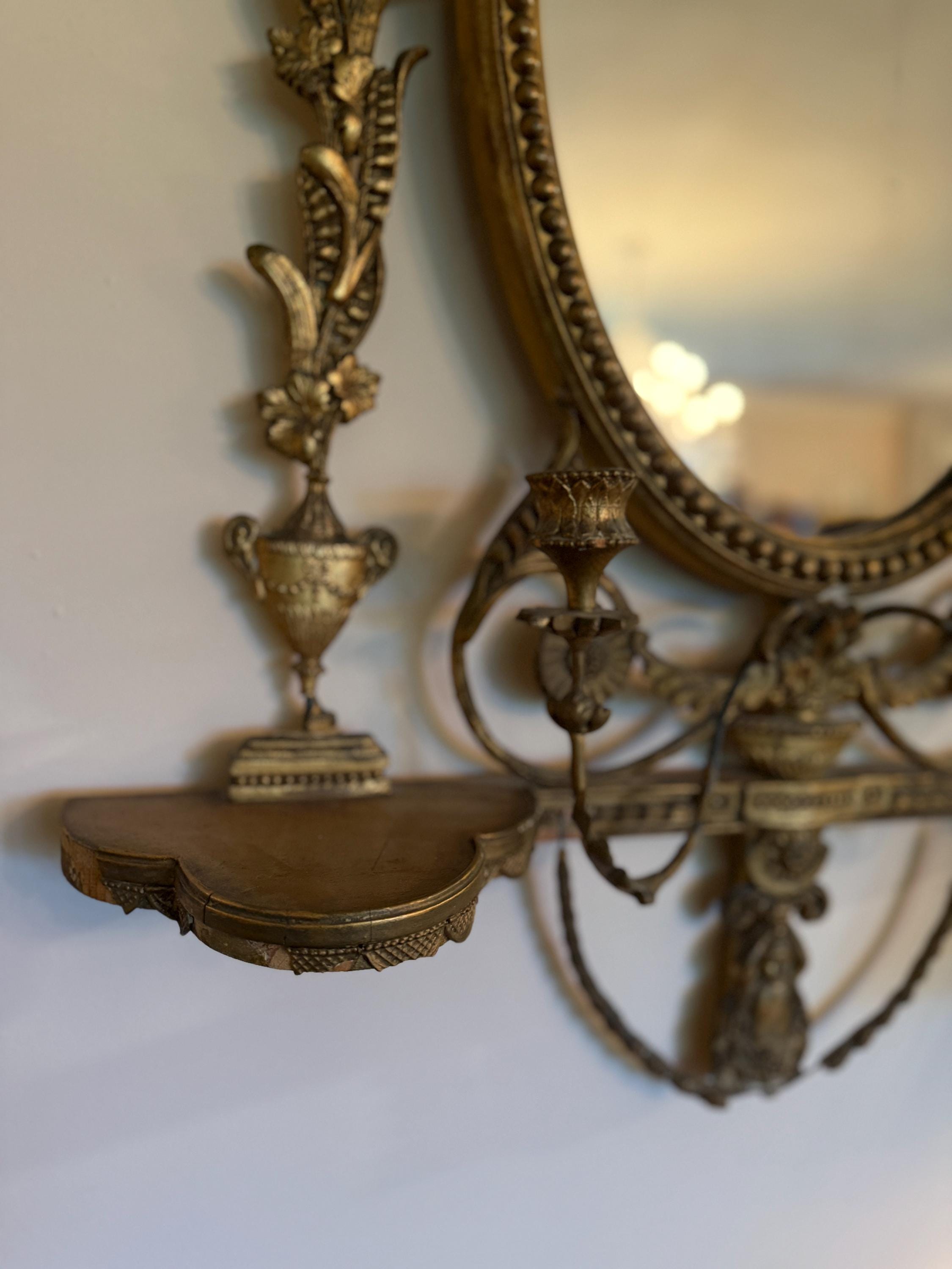 Antique French Wall Mirror 19th Century Oval Gilt Floral Wood Neoclassical Design Urn Garland Carvings Two Candle Shelves Luxurious Mirror